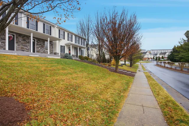 a view of a brick building next to a yard