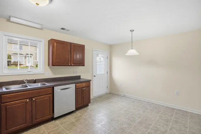 a kitchen with sink and cabinets