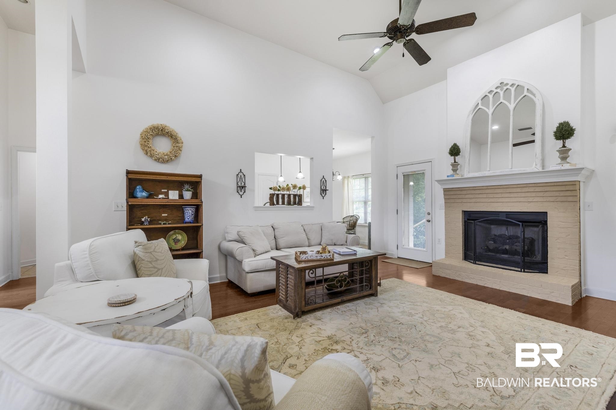 35814 Delvan Lane Bay Minette, AL 36507 - Photo 4 of 53 Spacious living area featuring a vaulted ceiling, wood-finish flooring, and a ceiling fan