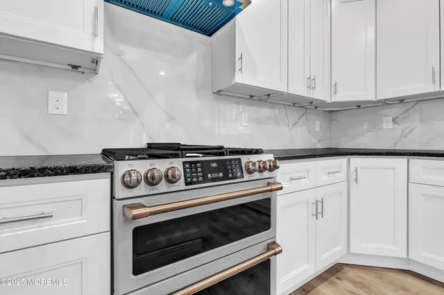 a stove top oven sitting inside of a kitchen