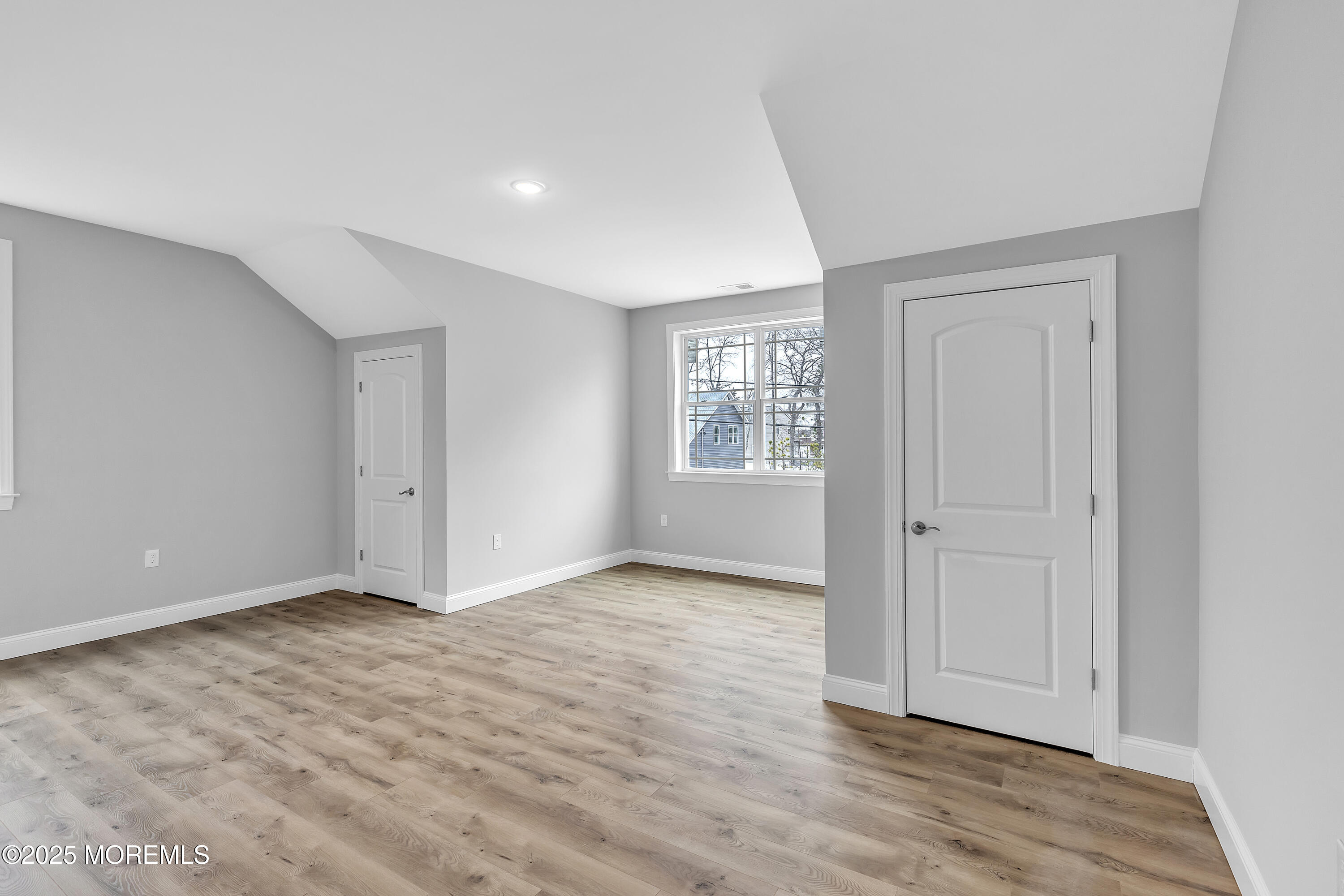 217 Nantucket Road Forked River, NJ 08731 - Photo 19 of 38 a view of an empty room with wooden floor and a window