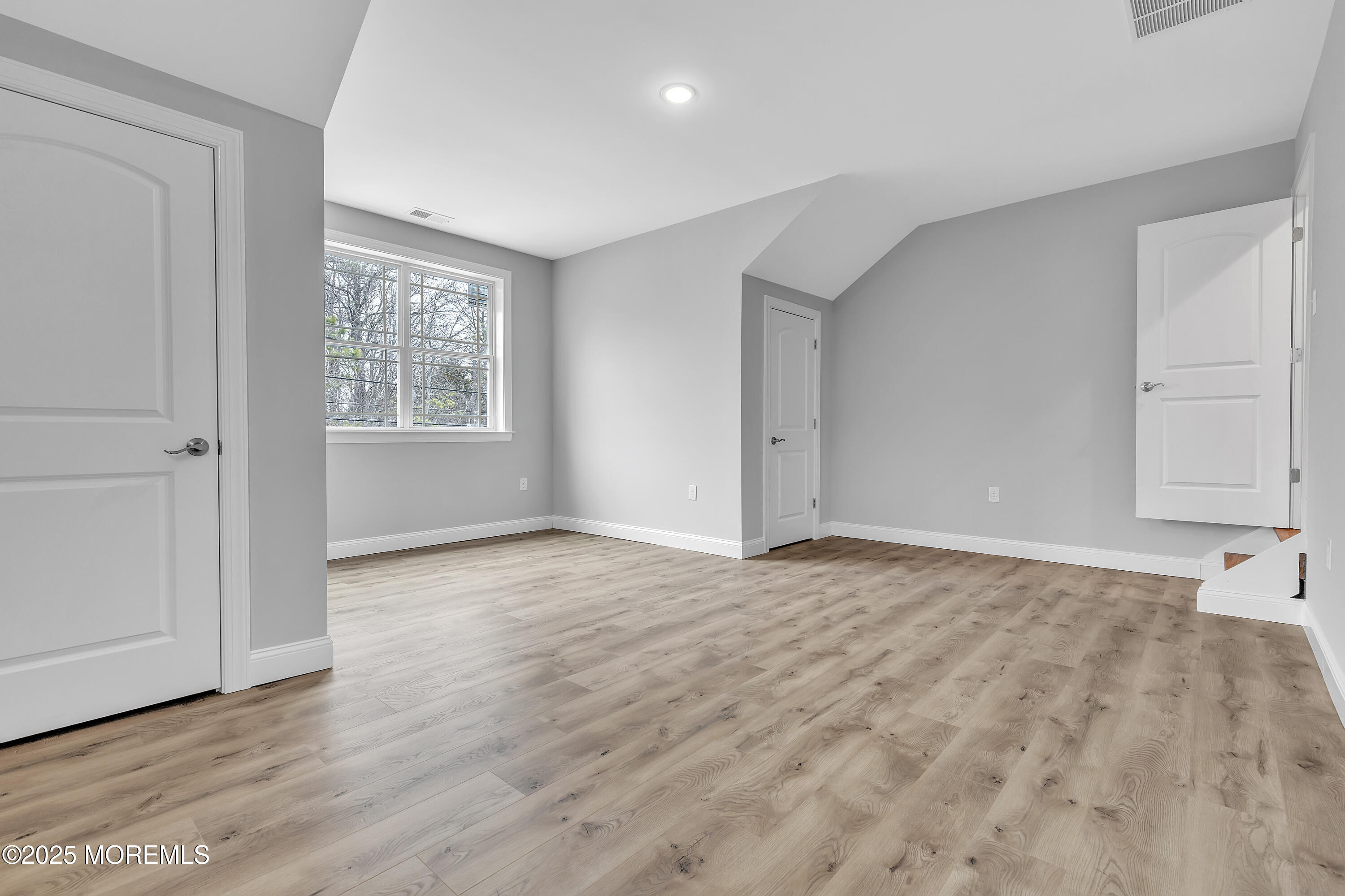 217 Nantucket Road Forked River, NJ 08731 - Photo 21 of 38 an empty room with wooden floor and windows