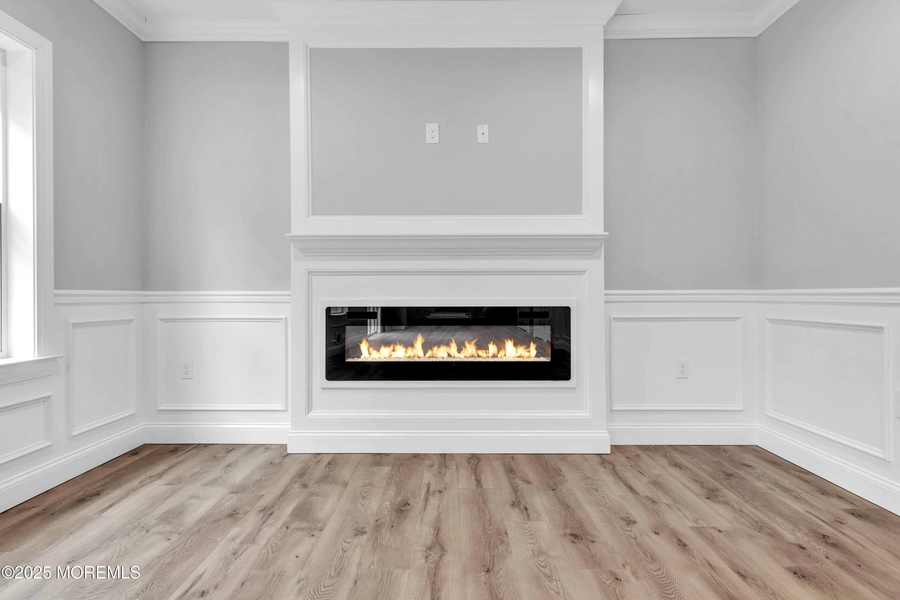 217 Nantucket Road Forked River, NJ 08731 - Photo 5 of 38 a view of an empty room with wooden floor fireplace and a window