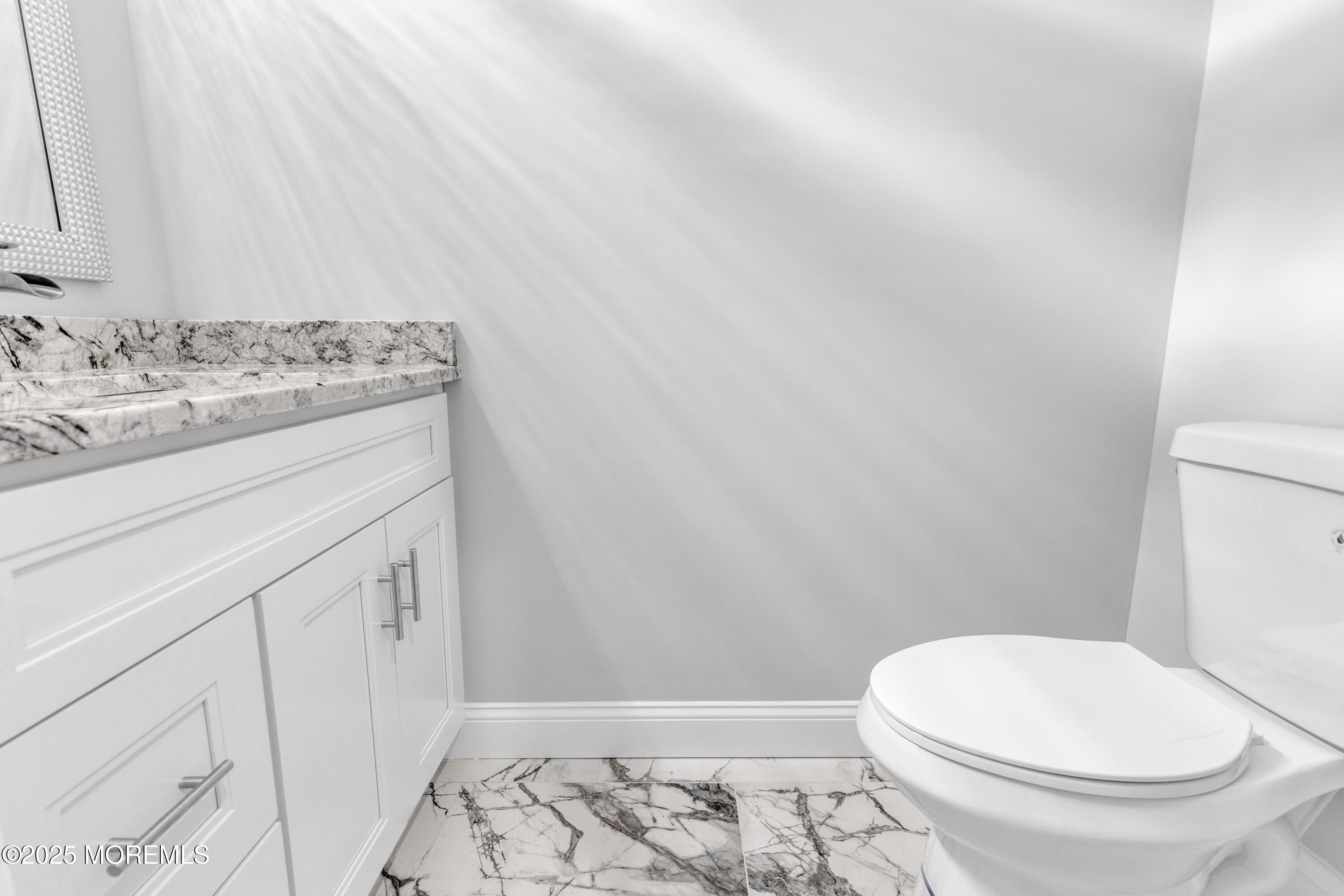 217 Nantucket Road Forked River, NJ 08731 - Photo 9 of 38 a bathroom with a granite countertop toilet and a sink