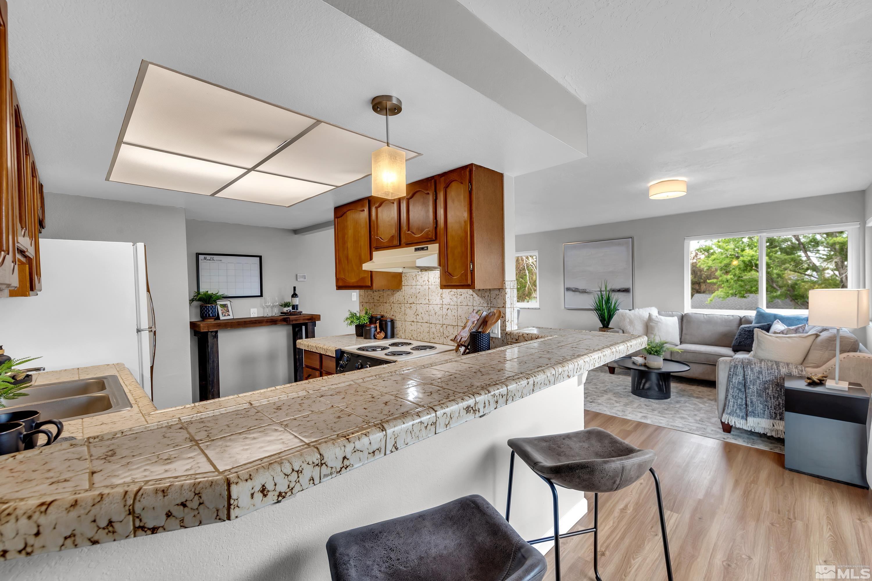 1415 Ebbetts Drive Reno, NV 89503 - Photo 24 of 36 a large kitchen with granite countertop lots of counter top space