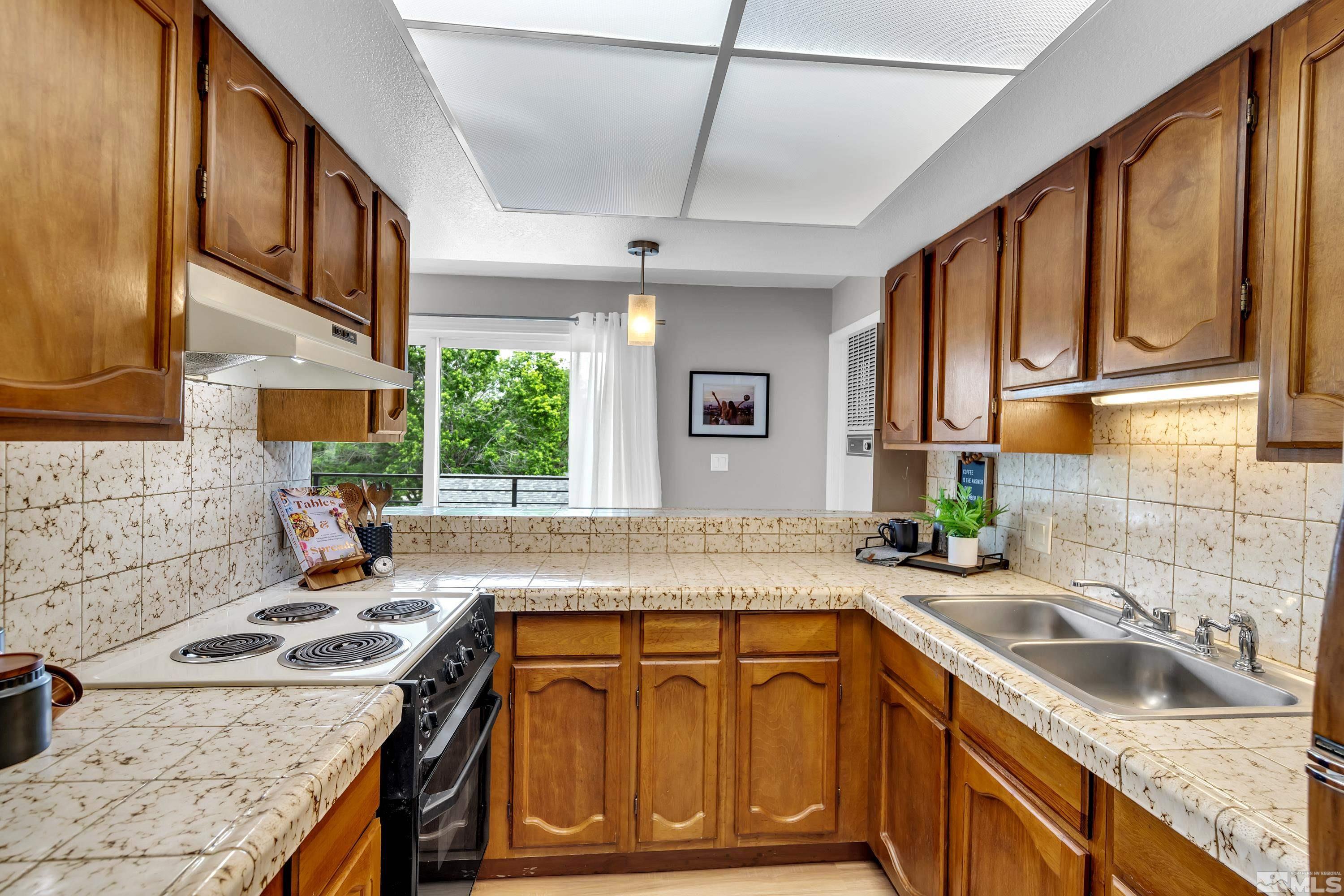 1415 Ebbetts Drive Reno, NV 89503 - Photo 27 of 36 a kitchen with stainless steel appliances granite countertop a sink stove and cabinets