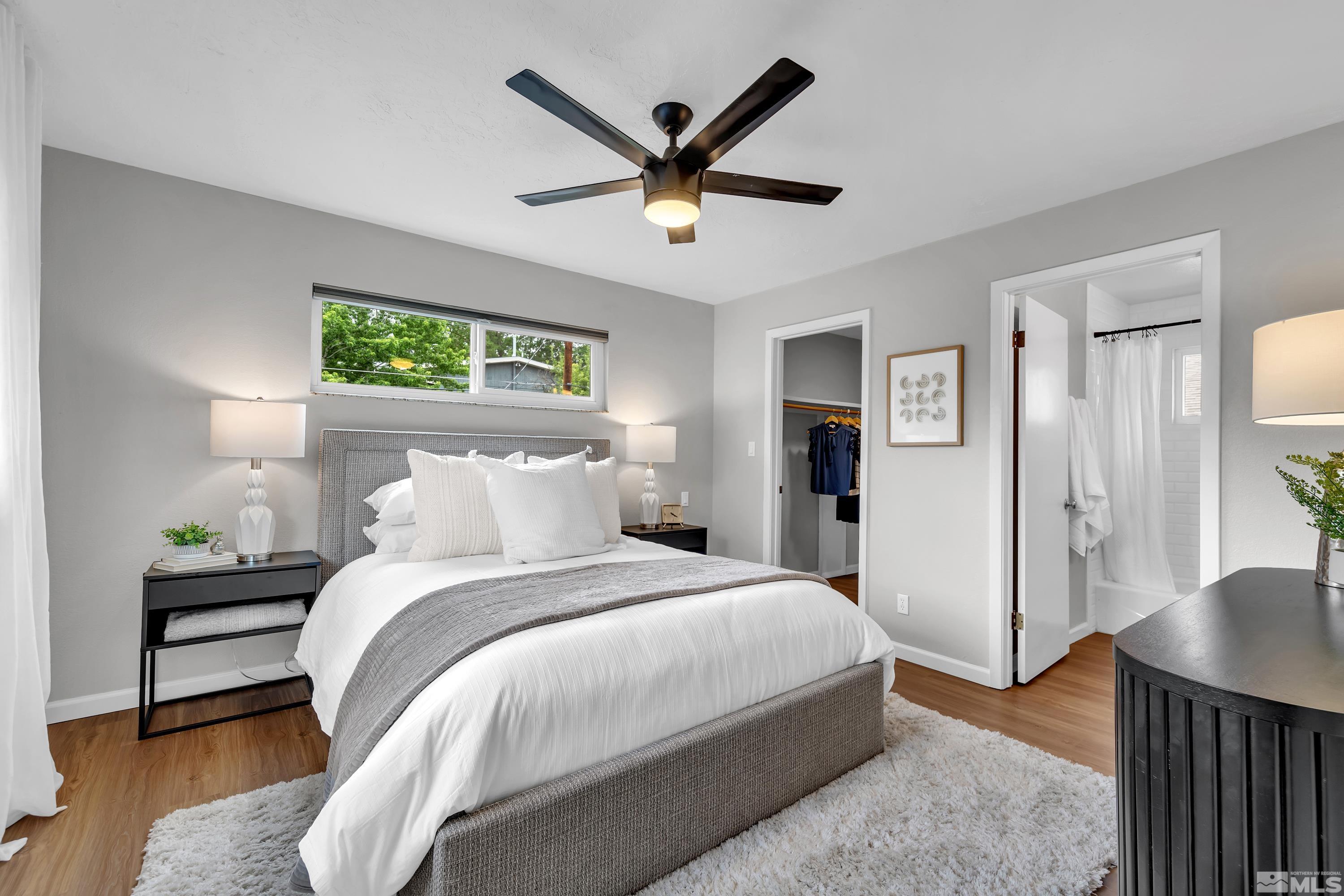 1415 Ebbetts Drive Reno, NV 89503 - Photo 28 of 36 a bedroom with a bed and a chandelier