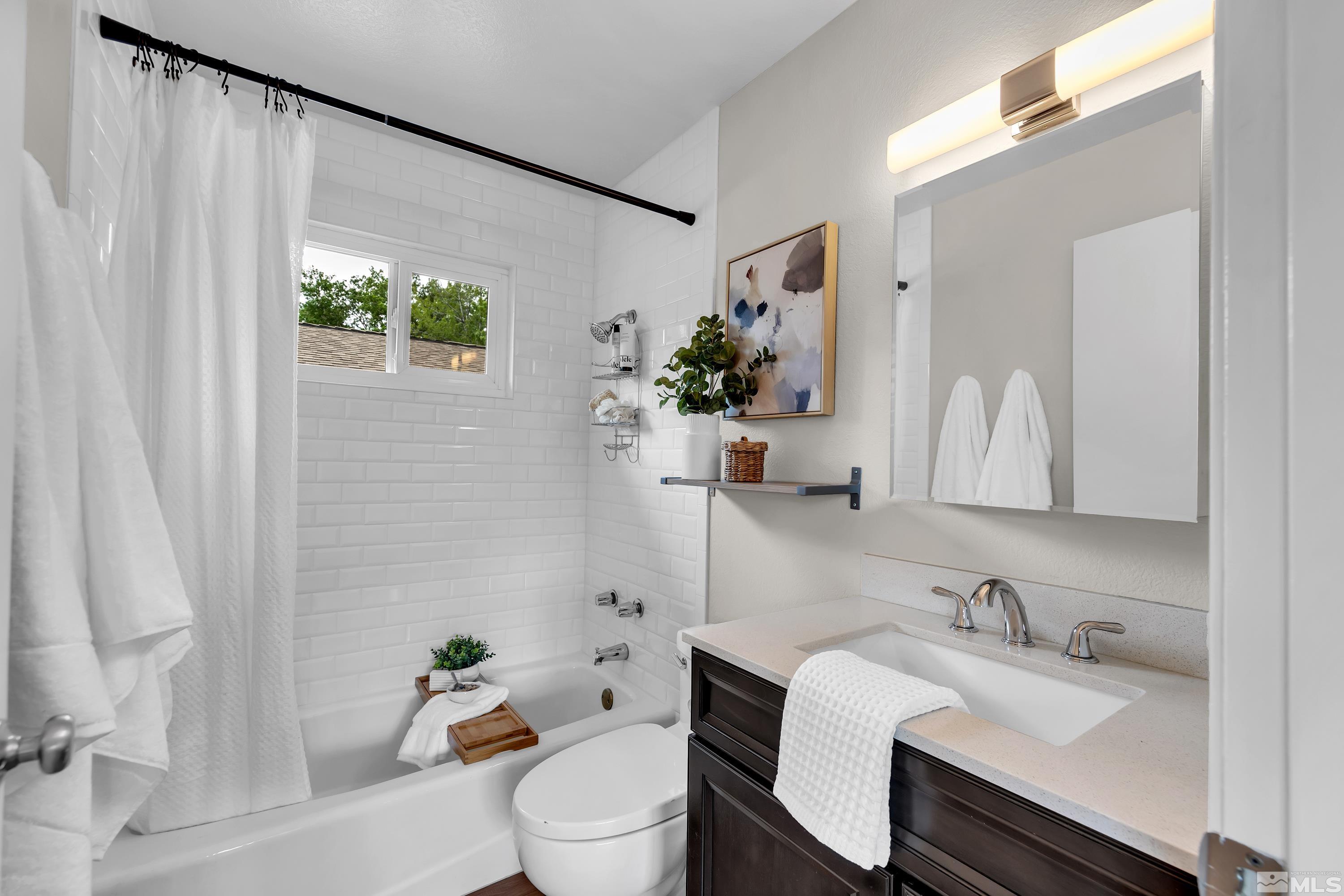 1415 Ebbetts Drive Reno, NV 89503 - Photo 31 of 36 a bathroom with a granite countertop sink and a toilet