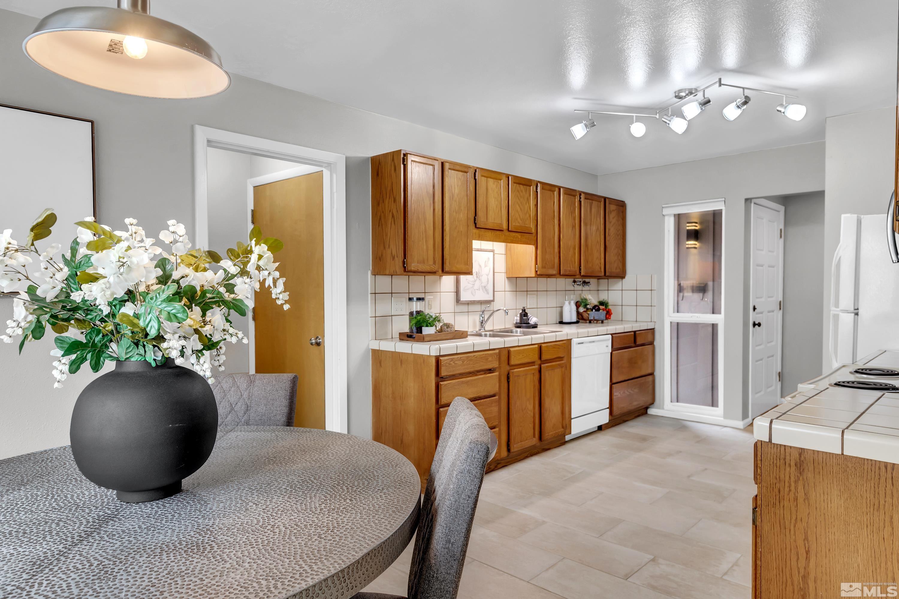 1415 Ebbetts Drive Reno, NV 89503 - Photo 7 of 36 a kitchen with stainless steel appliances granite countertop a sink a counter space and cabinets