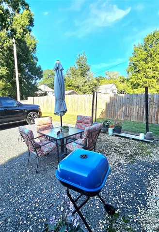 a view of a backyard with furniture and a garden