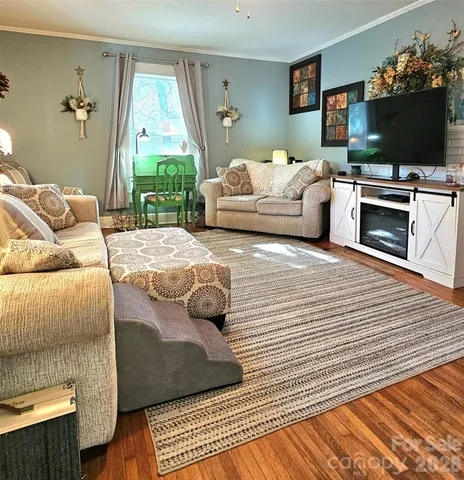 a living room with furniture and a flat screen tv