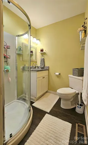 a bathroom with a granite countertop toilet sink and shower