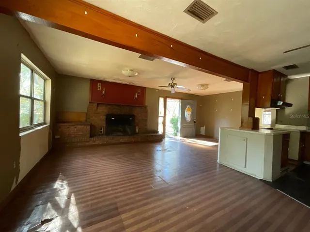 a view of open kitchen with furniture and wooden floor