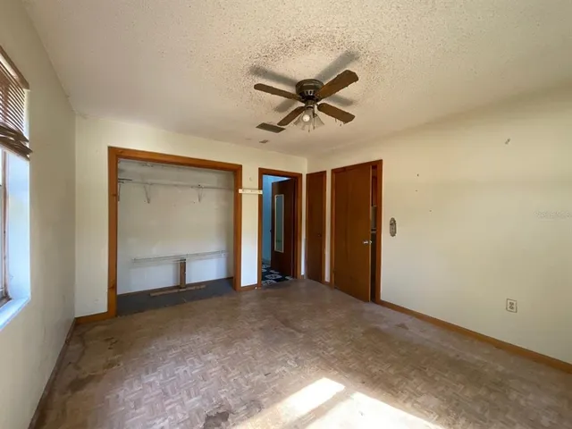 a view of empty room with ceiling fan