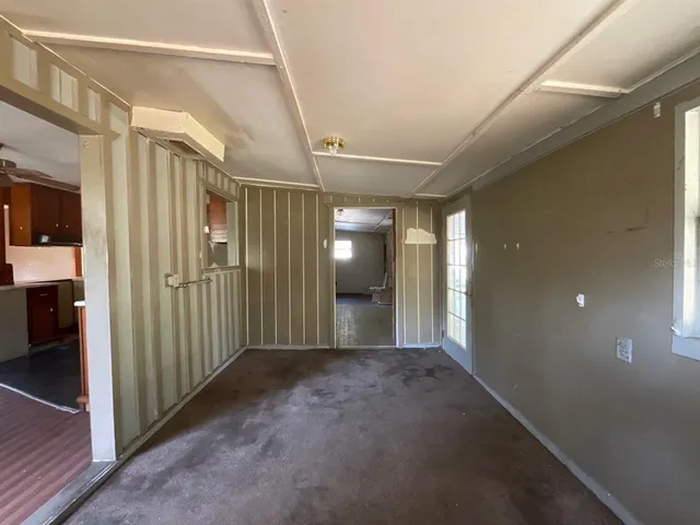 a view of a hallway with wooden shelves