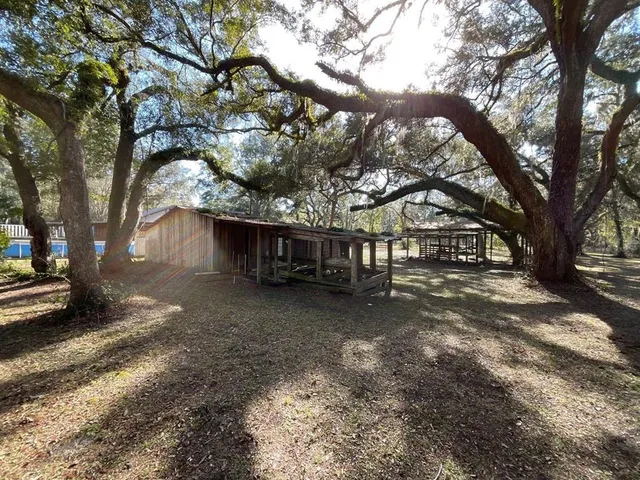 a view of a house with a tree