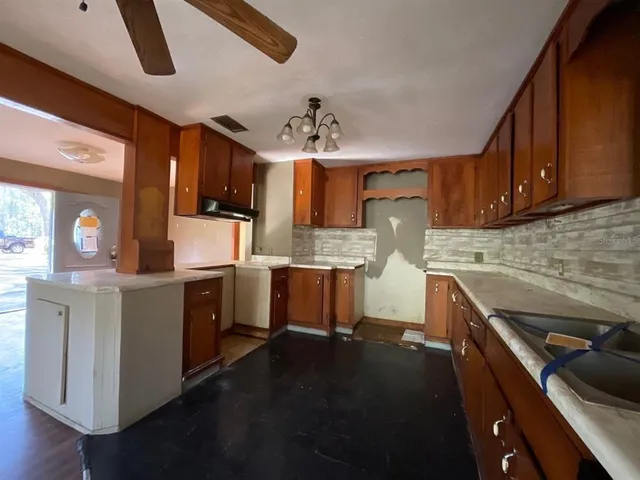 a kitchen with a sink appliances and cabinets