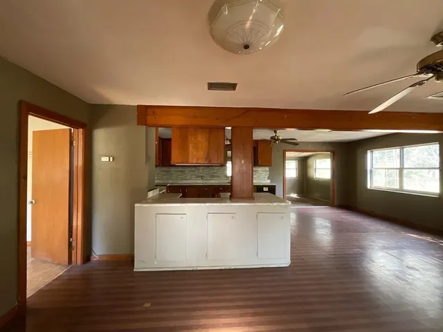 a view of a kitchen with a sink and a large window