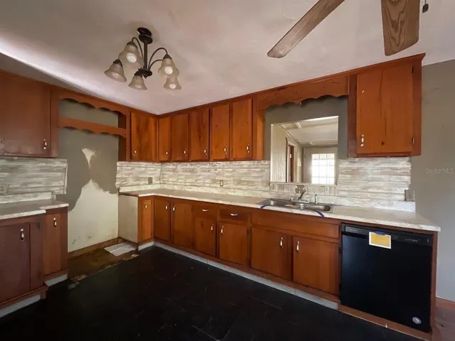 a kitchen with granite countertop cabinets stainless steel appliances a sink and a window