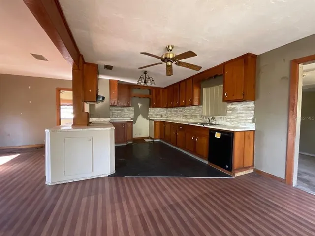 a kitchen with stainless steel appliances wooden floors and wooden cabinets
