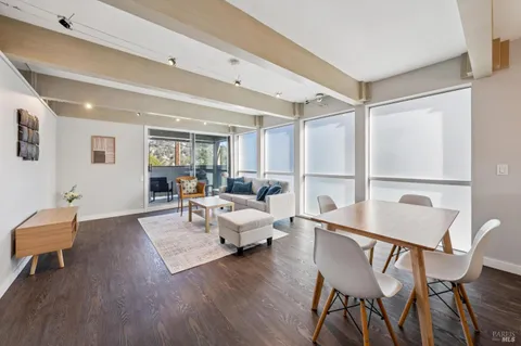 a dining room with furniture and wooden floor