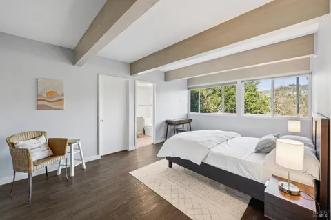 a bedroom with a bed and a potted plant