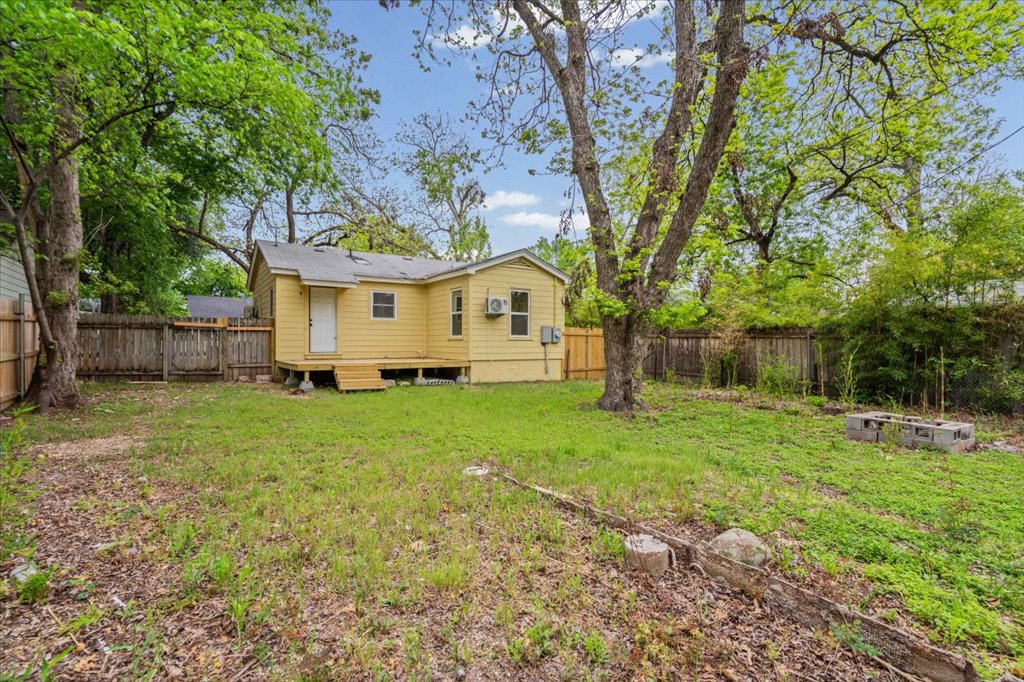 2206 Rountree Drive Austin, TX 78722 - Photo 15 of 16 a view of a big house with a big yard plants and large trees
