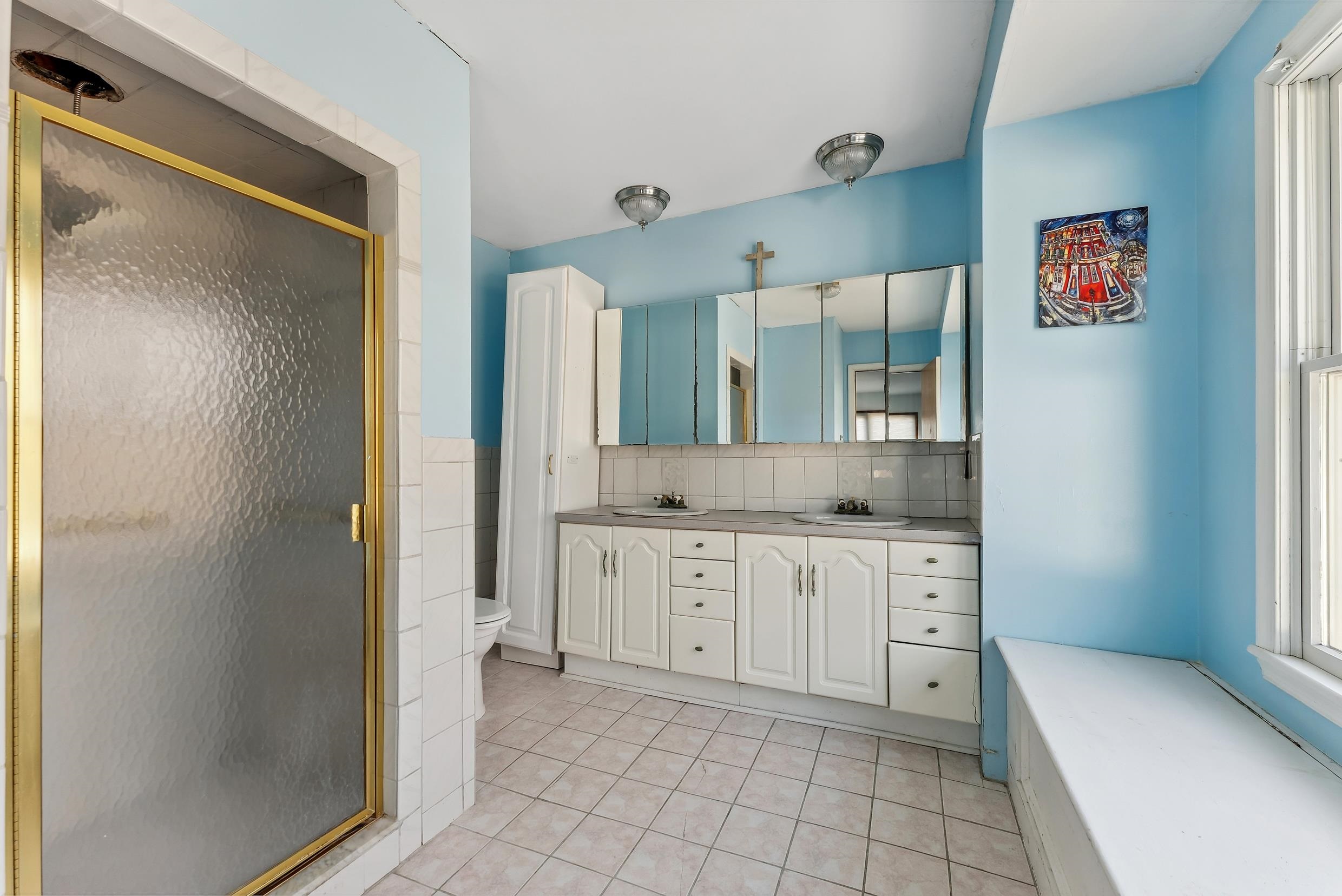 401 4th West Cape May, NJ 08204 - Photo 16 of 43 a spacious bathroom with a granite countertop sink mirror and a shower