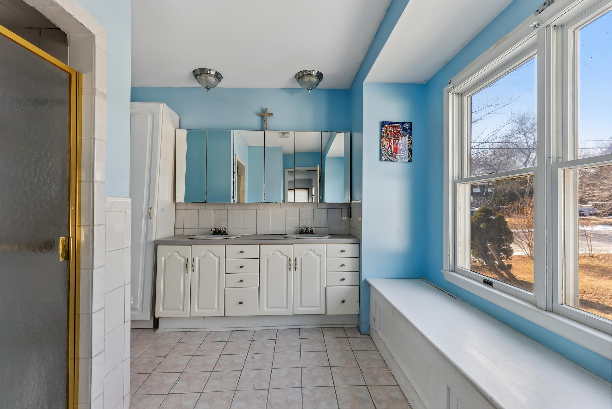 401 4th West Cape May, NJ 08204 - Photo 17 of 43 a bathroom with a granite countertop sink and a mirror