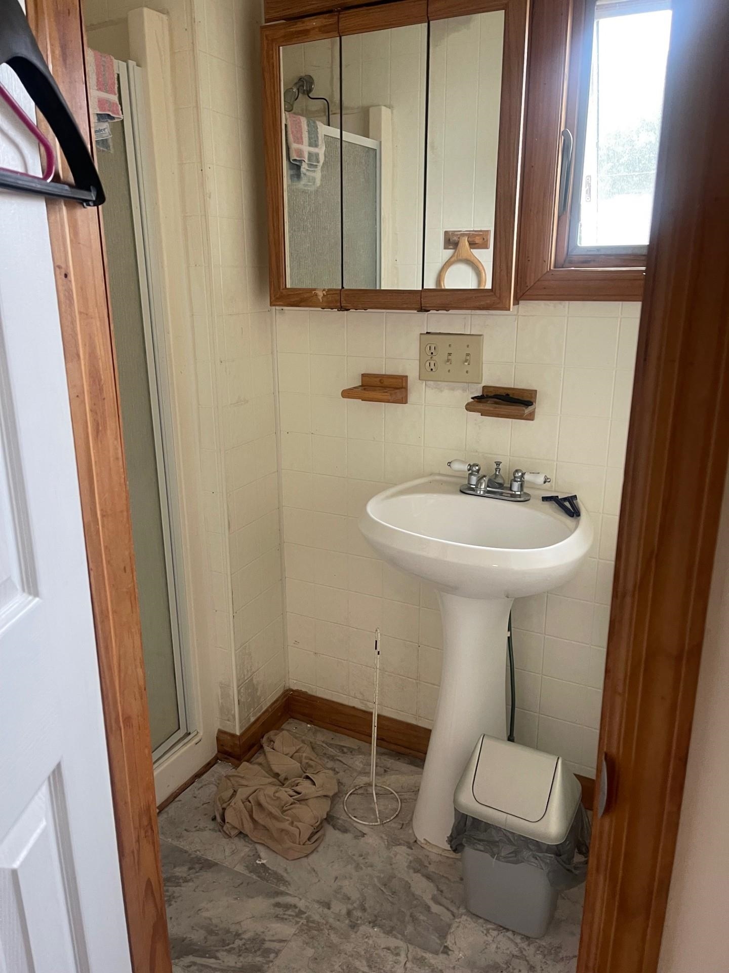 401 4th West Cape May, NJ 08204 - Photo 40 of 43 a bathroom with a sink a mirror and a toilet