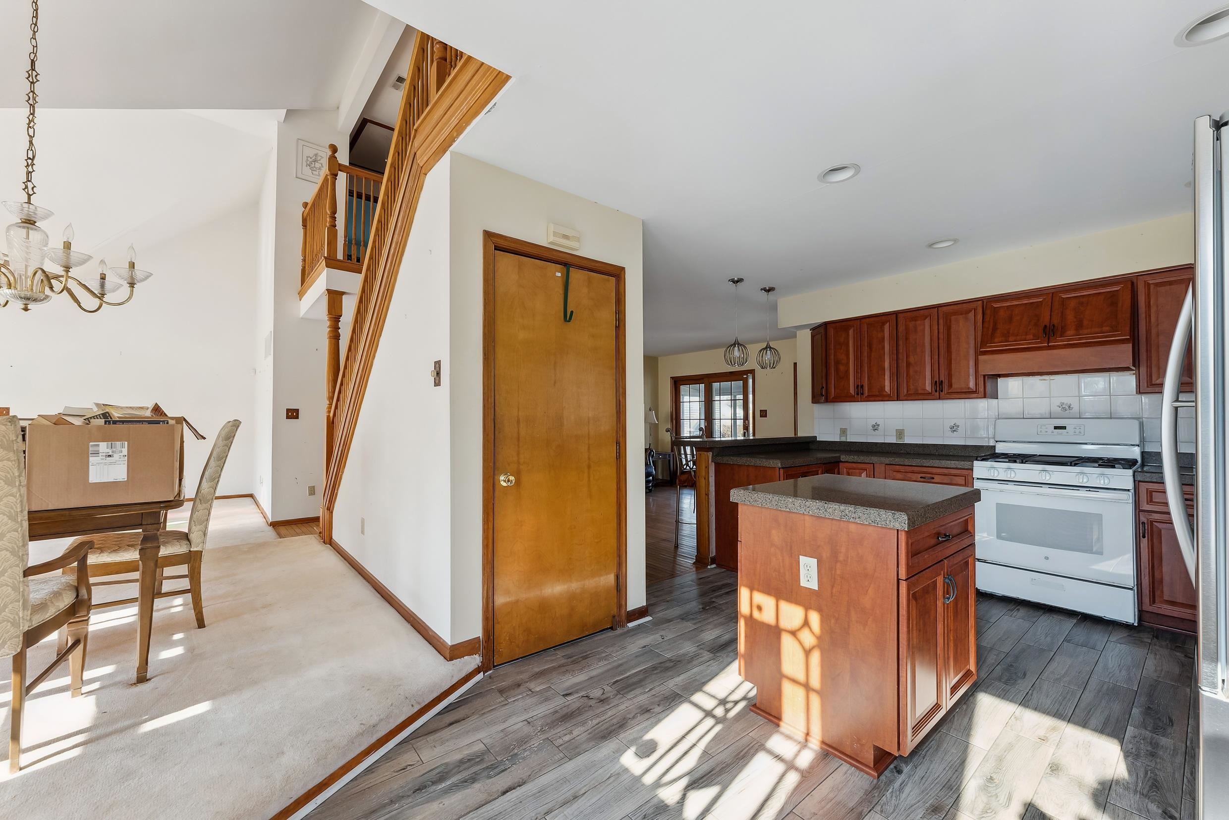 401 4th West Cape May, NJ 08204 - Photo 5 of 43 a kitchen with stainless steel appliances granite countertop a refrigerator and a stove top oven with wooden floor