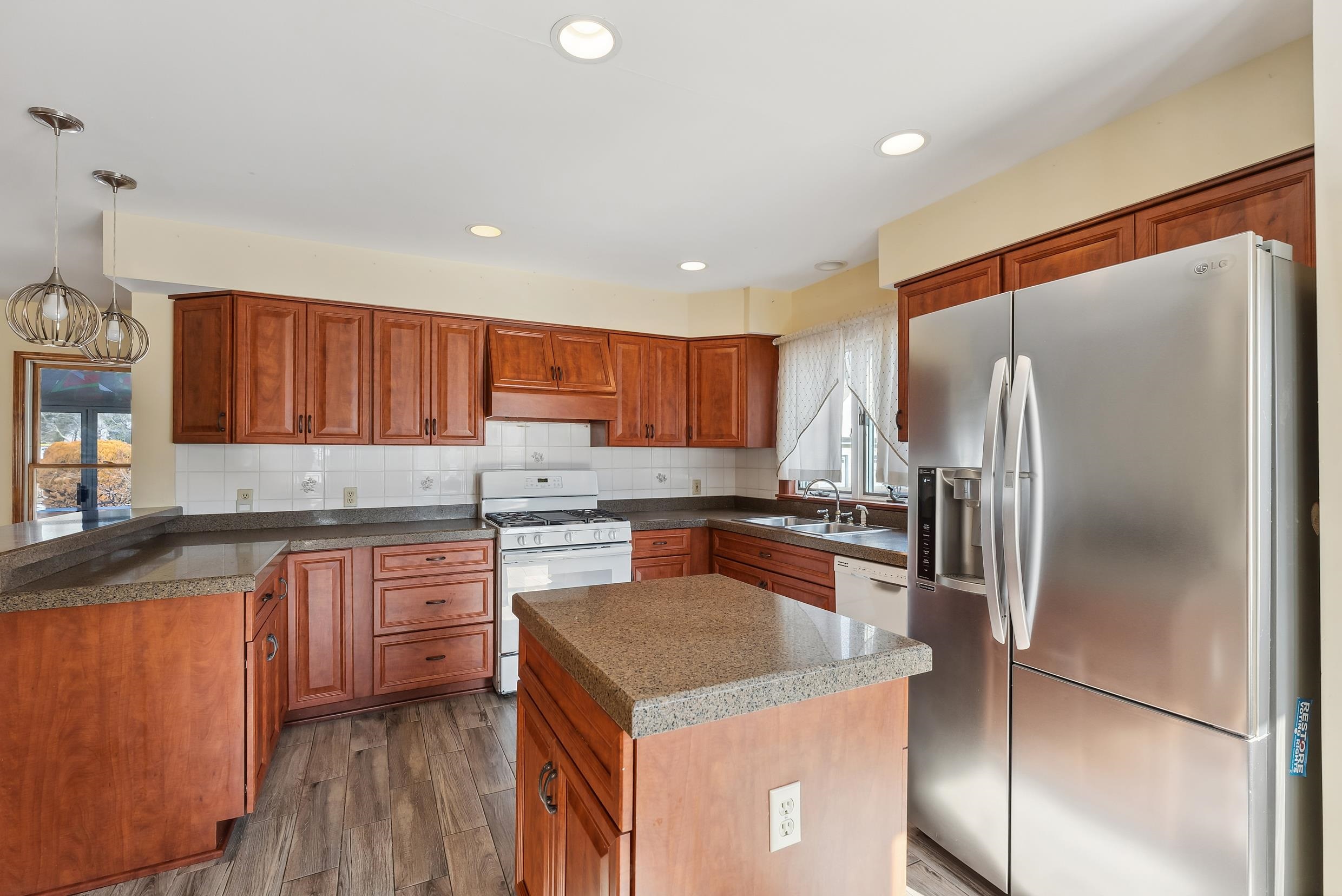 401 4th West Cape May, NJ 08204 - Photo 6 of 43 a kitchen with a refrigerator a sink and cabinets