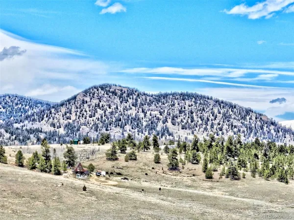 a view of a town with mountains in the background