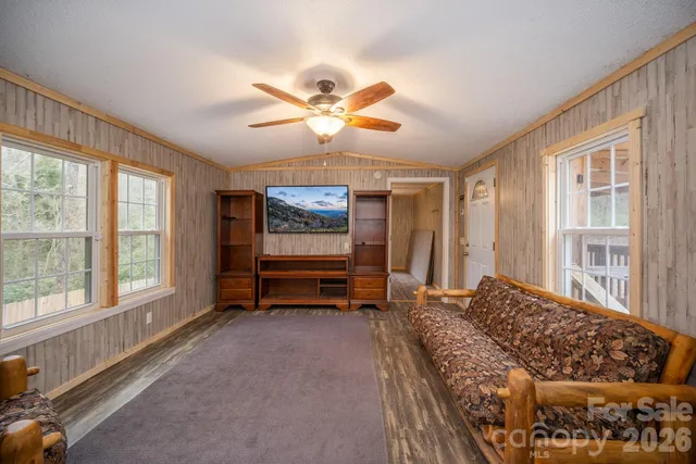 a bedroom with furniture and a large window