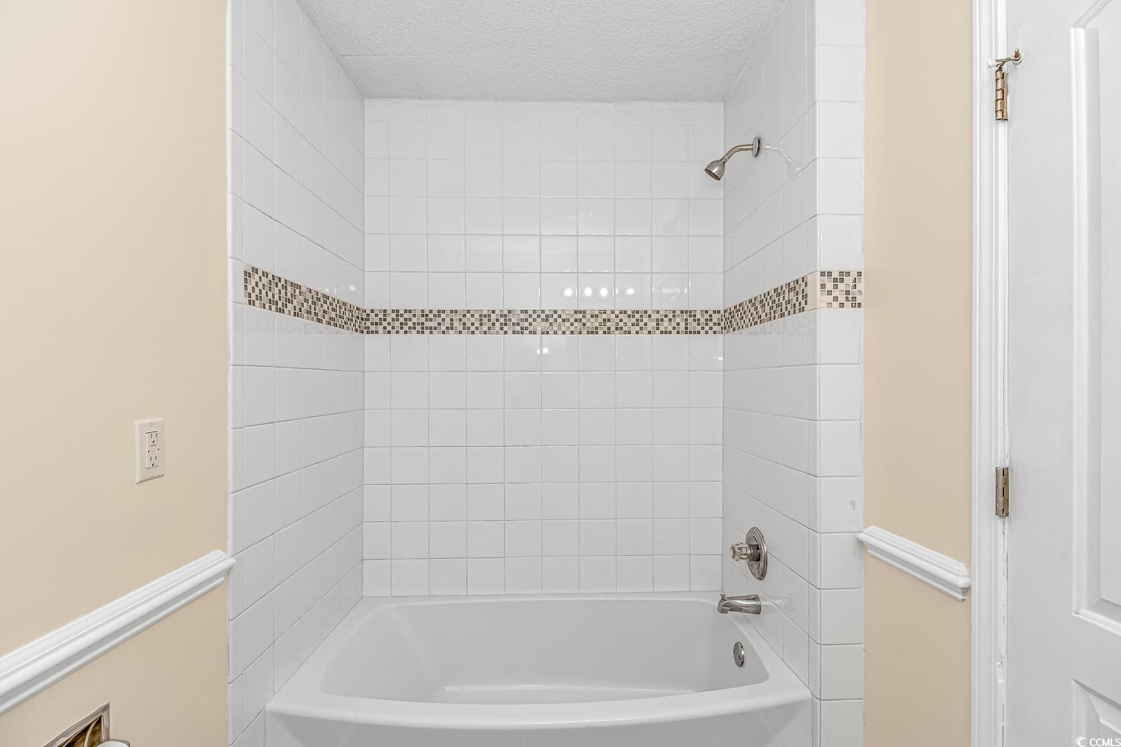 918 Forest Loop Road Conway, SC 29527 - Photo 11 of 26 Bathroom with a textured ceiling and tiled shower