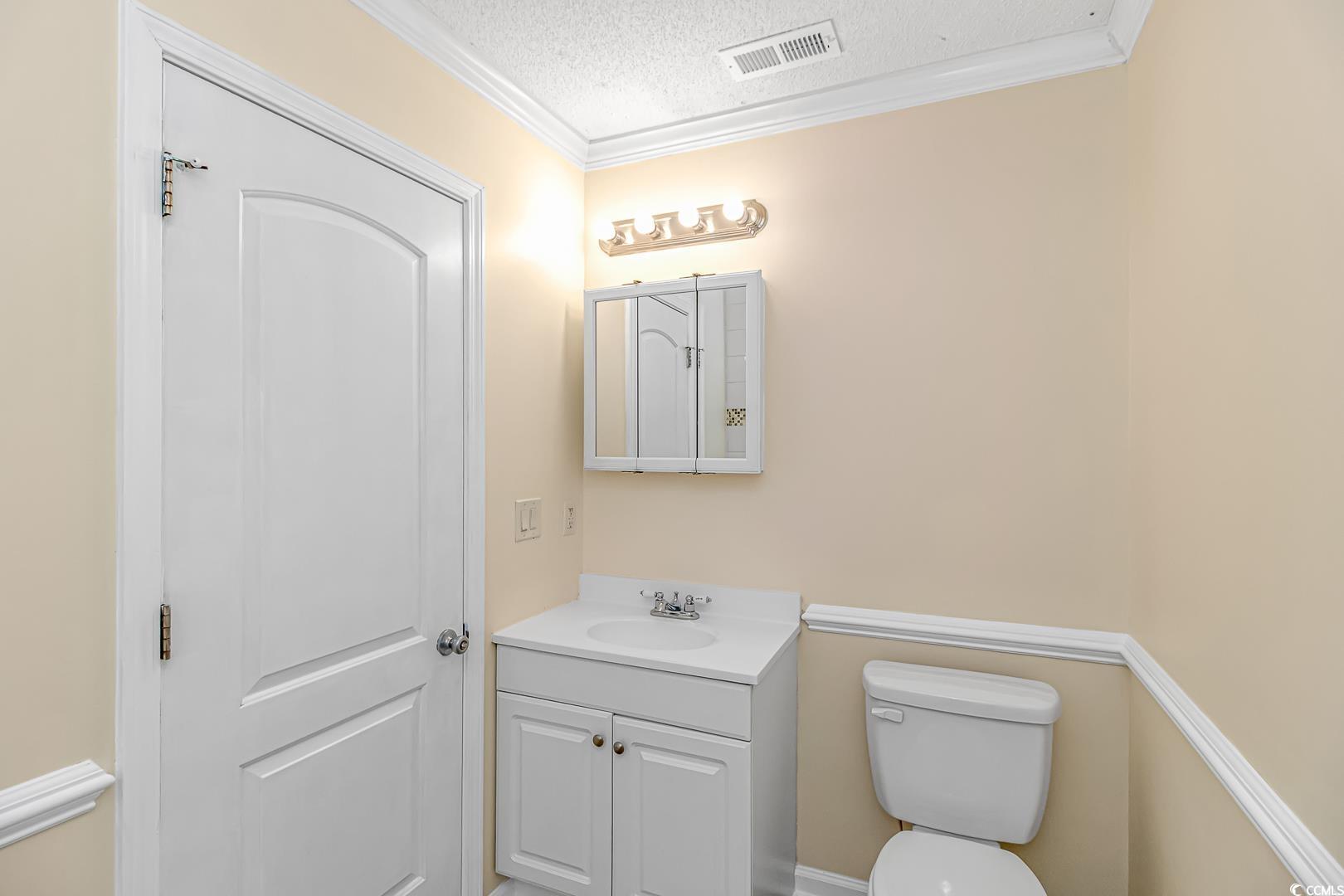 918 Forest Loop Road Conway, SC 29527 - Photo 12 of 26 Bathroom featuring vanity, ornamental molding, a t