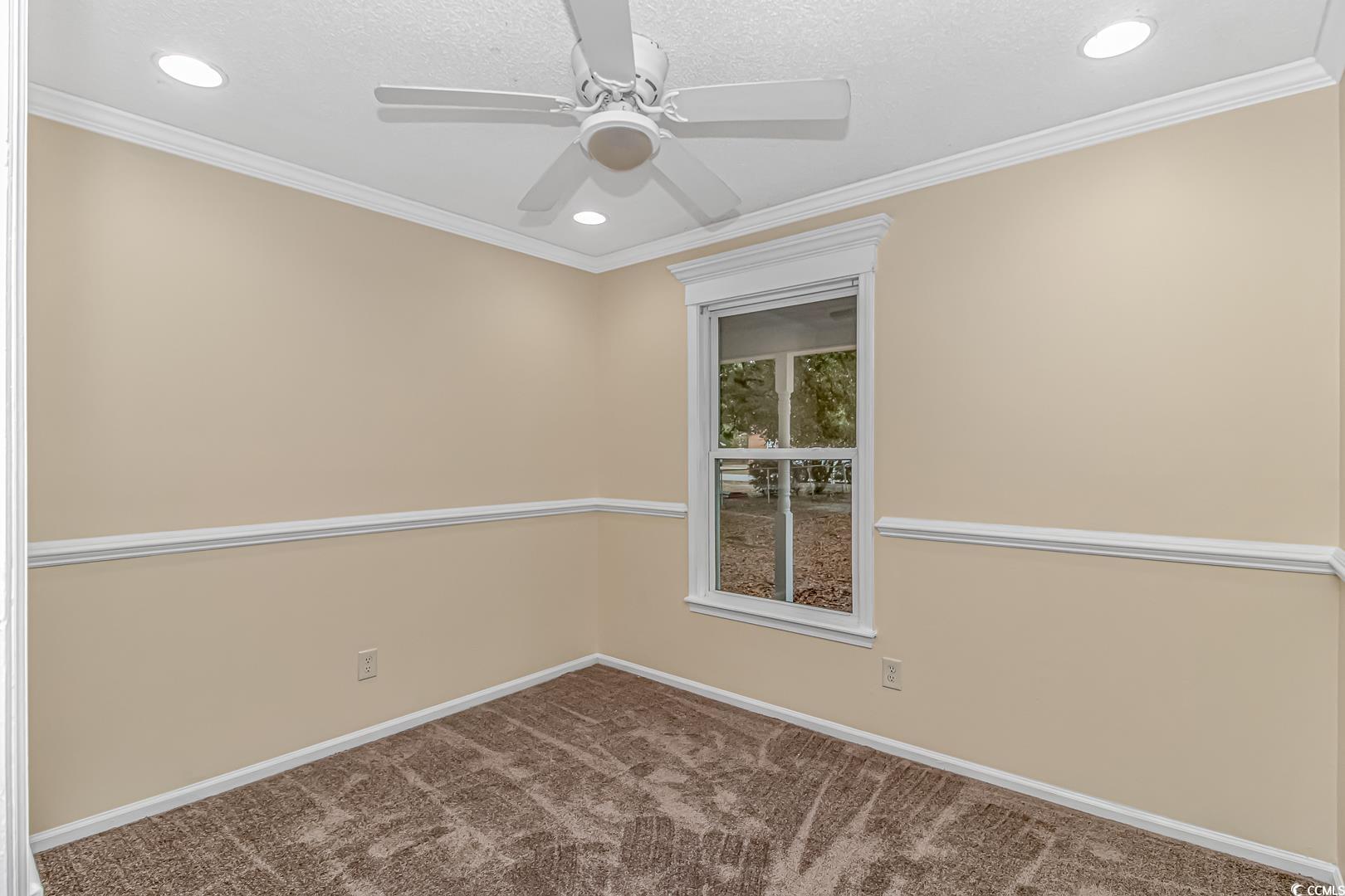 918 Forest Loop Road Conway, SC 29527 - Photo 18 of 26 Empty room featuring carpet, ceiling fan, and orna