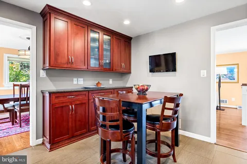 a dining room with a wooden table and chairs