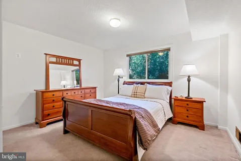 a bedroom with a bed and a dresser