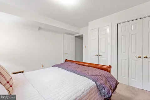 a bedroom with a bed and a hallway