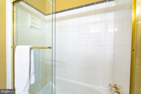 a bathroom with a shower and a bath tub