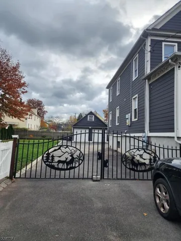 a couple of cars parked in front of a house