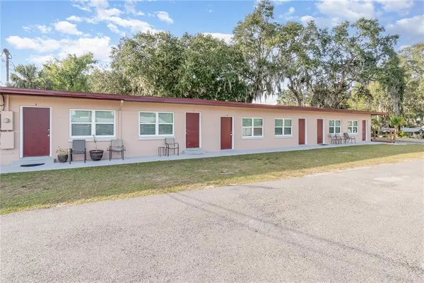 a view of a house with a yard and garage