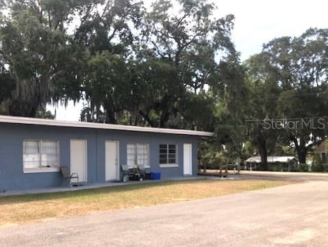1401 East Alfred Street, Unit 9 Tavares, FL 32778 - Photo 1 of 18 a view of a house with a yard and large tree