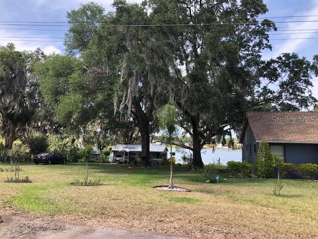 1401 East Alfred Street, Unit 9 Tavares, FL 32778 - Photo 13 of 18 a backyard of a house with lots of green space
