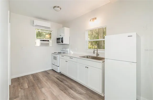 a kitchen with a white cabinets and white appliances