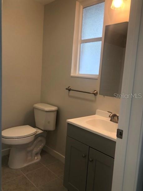 1401 East Alfred Street, Unit 9 Tavares, FL 32778 - Photo 7 of 18 a bathroom with a sink toilet and mirror