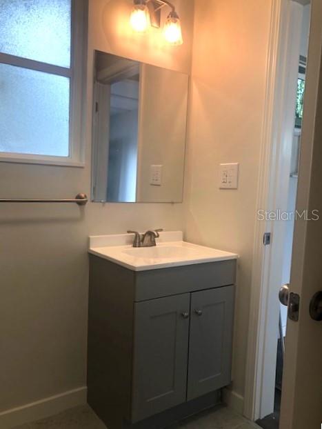 1401 East Alfred Street, Unit 9 Tavares, FL 32778 - Photo 9 of 18 a bathroom with a sink and mirror
