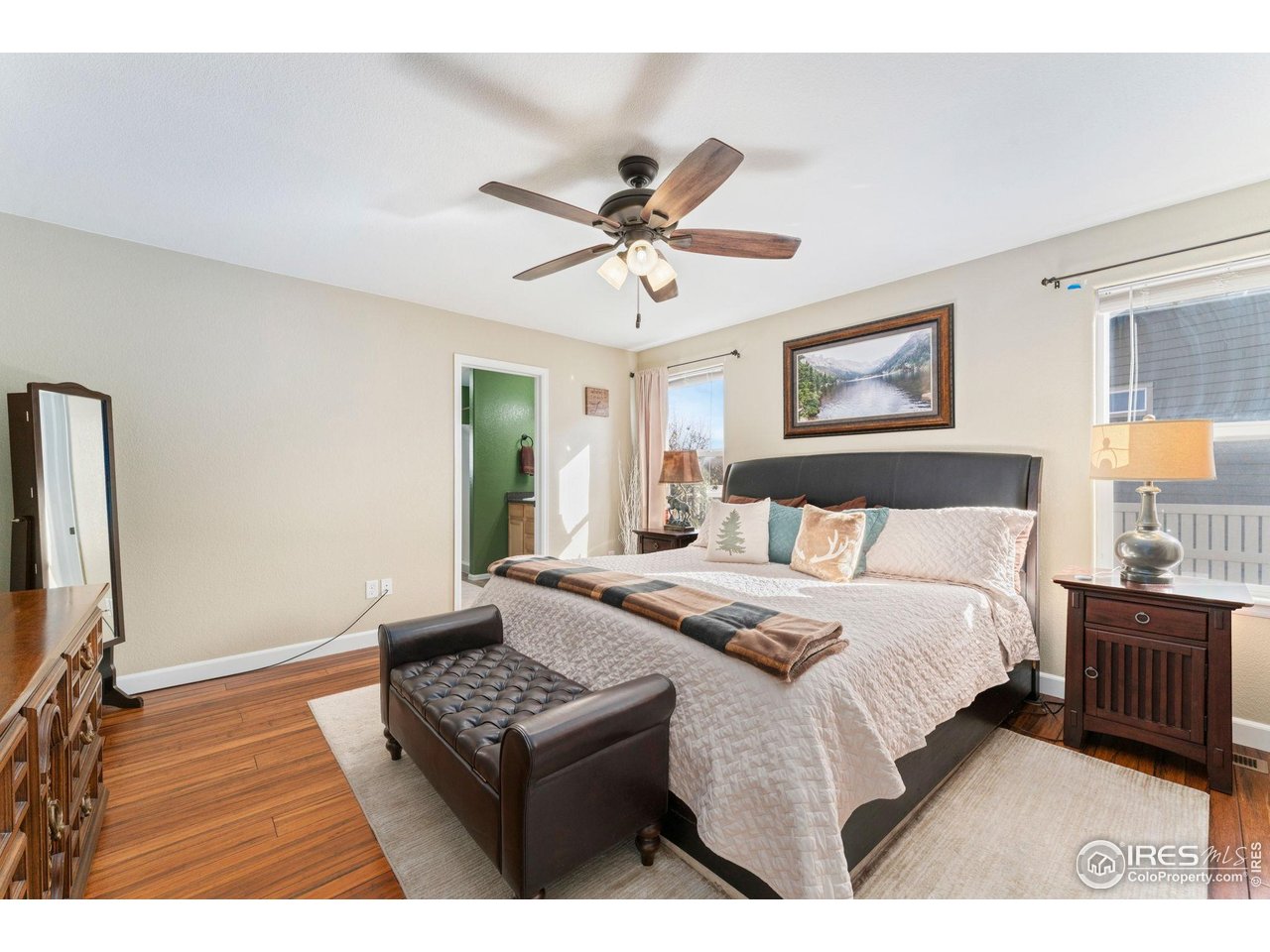 11420 Coal Ridge Street Firestone, CO 80504 - Photo 12 of 31 a bedroom with a bed a dresser and a window