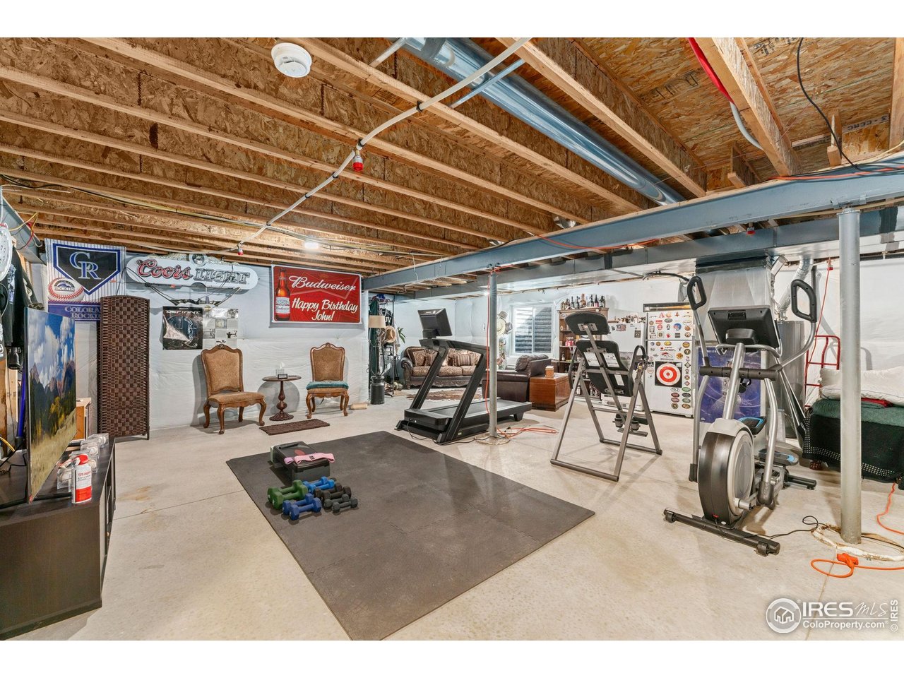 11420 Coal Ridge Street Firestone, CO 80504 - Photo 17 of 31 a living room with lots of furniture and a view of bedroom